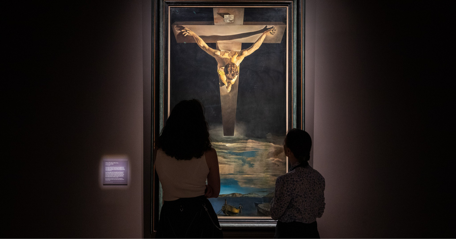 two women admiring Dali's Christ on the Cross painting at The Spanish Gallery